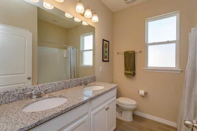 bathroom featuring vanity, hardwood / wood-style flooring, toilet, and a shower with shower curtain