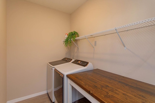 laundry room featuring hardwood / wood-style flooring and independent washer and dryer