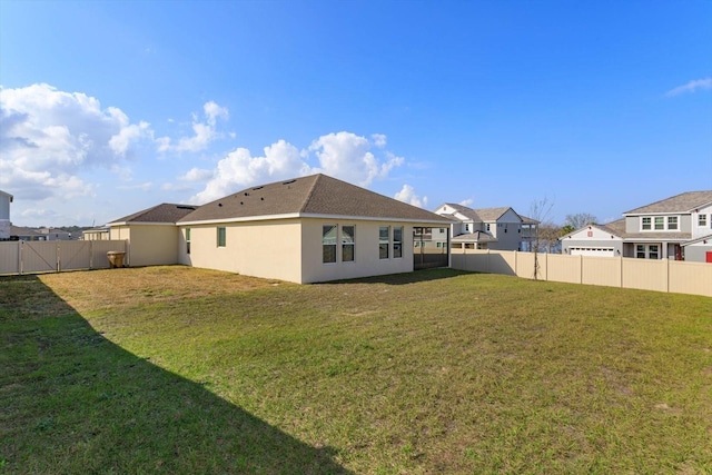 rear view of house with a lawn