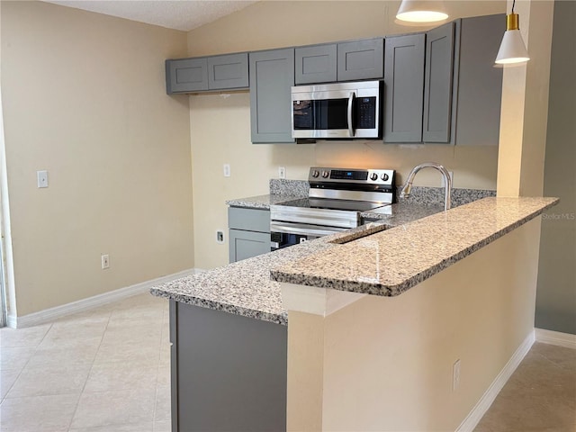 kitchen featuring pendant lighting, gray cabinets, appliances with stainless steel finishes, light stone counters, and kitchen peninsula