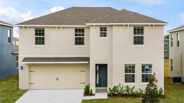 view of front of home with cooling unit and a garage