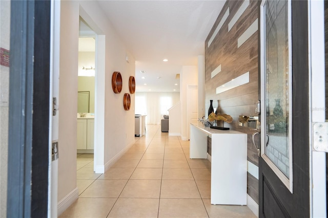 hall featuring light tile patterned floors