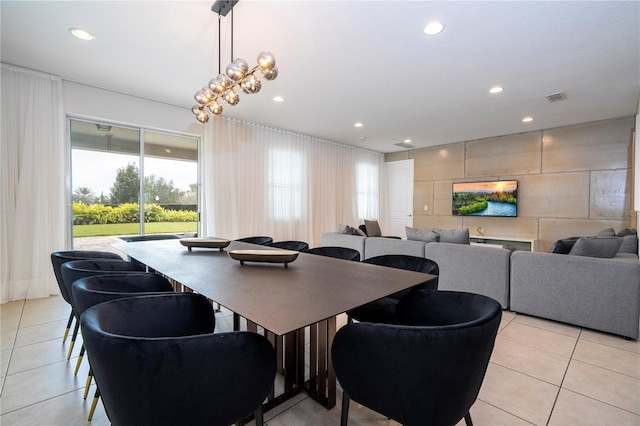 tiled dining space featuring an inviting chandelier