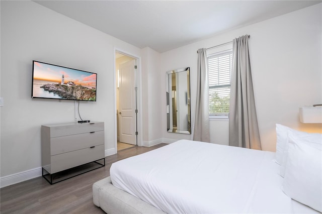 bedroom with hardwood / wood-style flooring