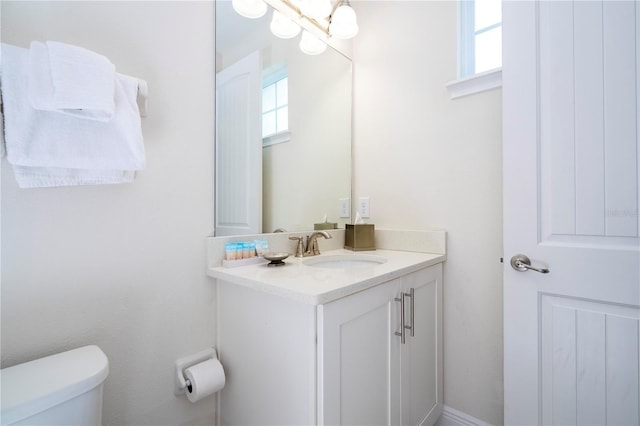 bathroom featuring vanity and toilet