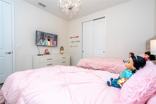 bedroom with a chandelier and a closet