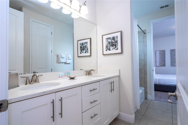 bathroom with an inviting chandelier, washtub / shower combination, vanity, and tile patterned flooring