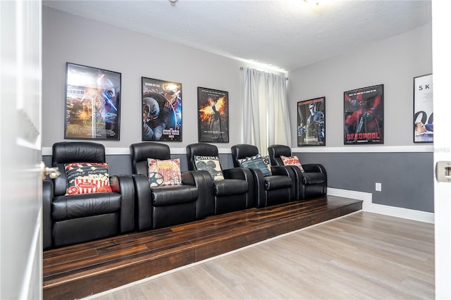 home theater featuring wood-type flooring and a textured ceiling