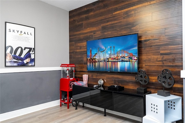 living room with wood-type flooring and wood walls