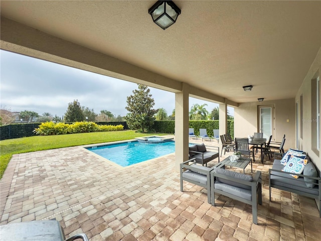 view of pool featuring an in ground hot tub, a yard, and a patio area