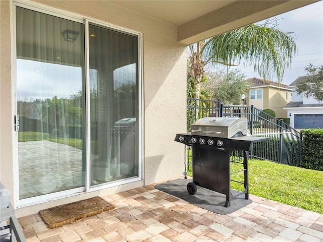 view of patio with a grill and a balcony