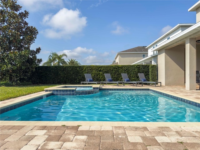 view of swimming pool featuring an in ground hot tub and a patio area