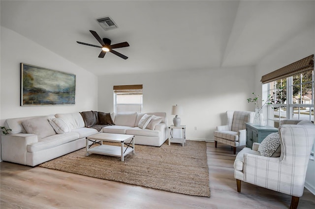 living room with lofted ceiling, ceiling fan, plenty of natural light, and wood-type flooring