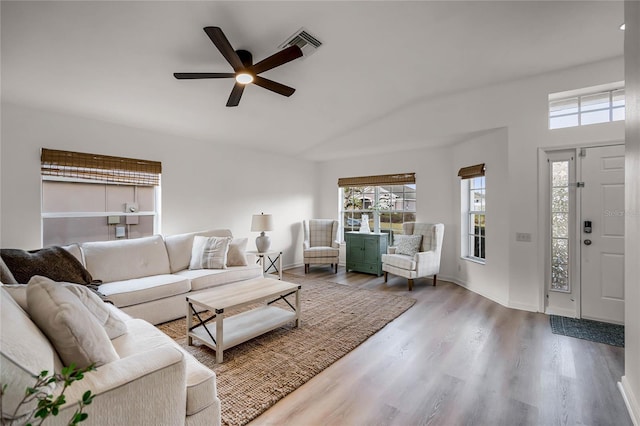 living room with lofted ceiling, hardwood / wood-style floors, and ceiling fan