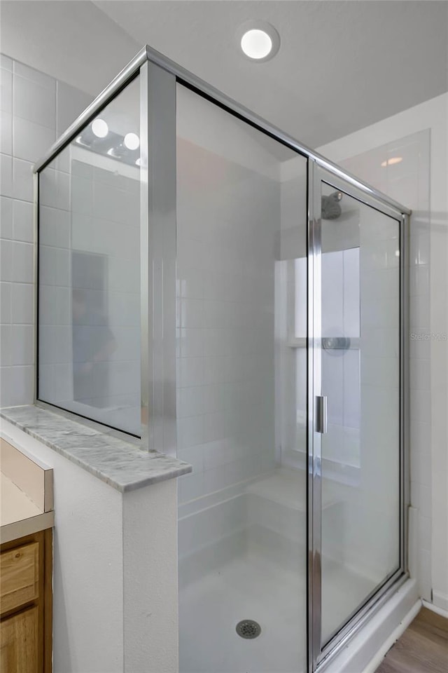 bathroom with a shower with shower door