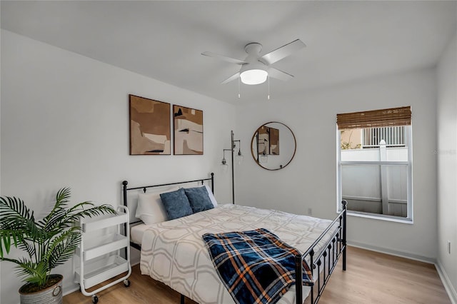 bedroom with hardwood / wood-style flooring and ceiling fan