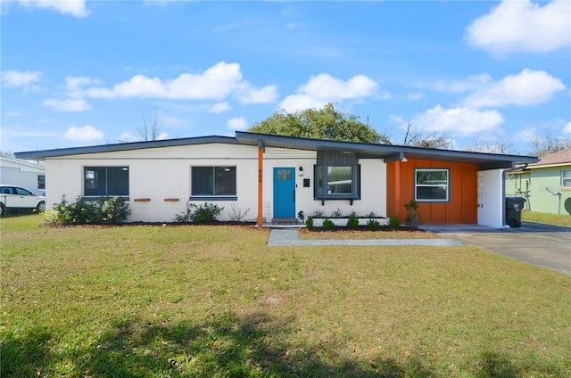 single story home featuring driveway, a front lawn, and board and batten siding