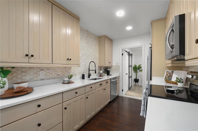 kitchen featuring stainless steel appliances, light countertops, and a sink