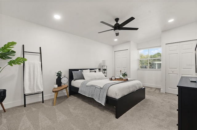 bedroom featuring baseboards, a ceiling fan, carpet flooring, multiple closets, and recessed lighting