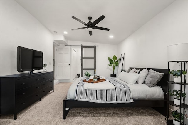 bedroom featuring recessed lighting, a barn door, light carpet, ceiling fan, and vaulted ceiling