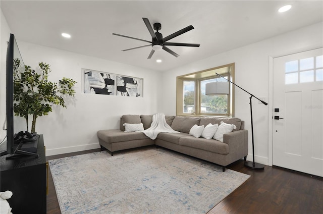 living room featuring baseboards, ceiling fan, dark wood-style flooring, and recessed lighting