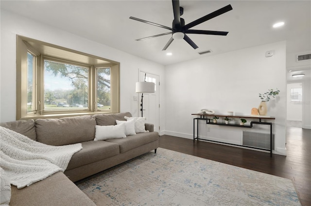 living area featuring recessed lighting, visible vents, dark wood finished floors, and baseboards