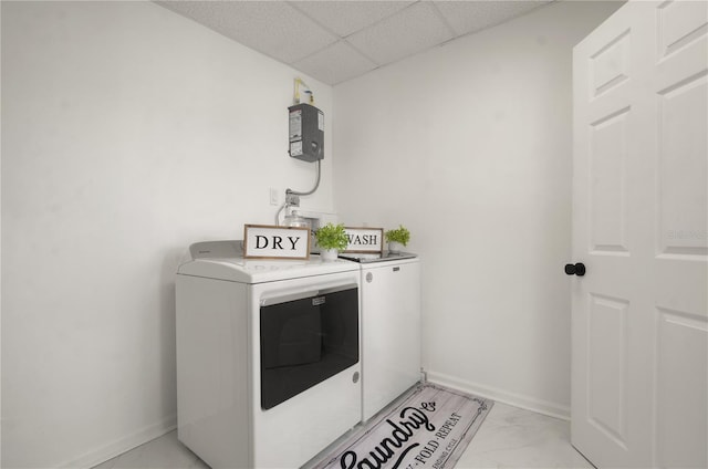 washroom with laundry area, baseboards, marble finish floor, and washing machine and clothes dryer