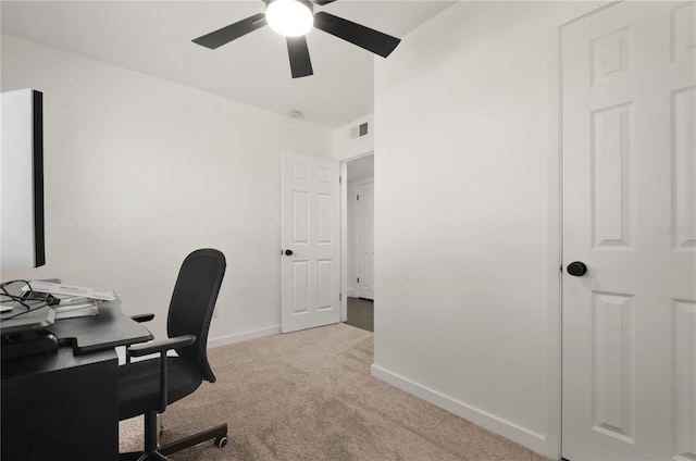 home office featuring light carpet, ceiling fan, visible vents, and baseboards