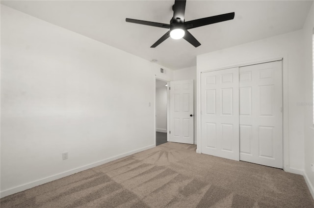 unfurnished bedroom featuring a closet, carpet, visible vents, and baseboards