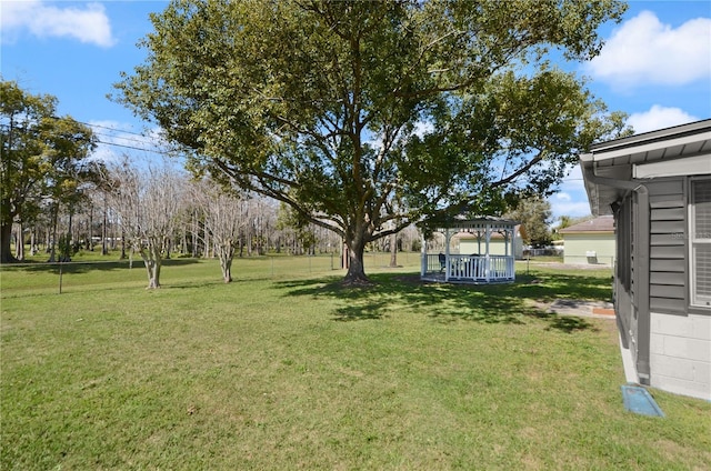 view of yard with fence and a gazebo