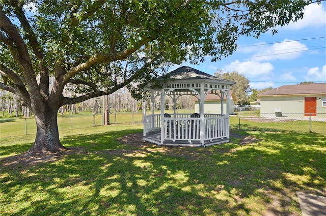 view of home's community featuring a yard, a fenced backyard, and a gazebo