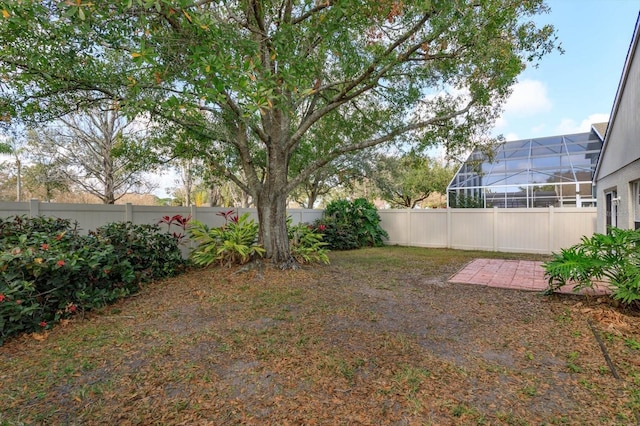 view of yard featuring glass enclosure