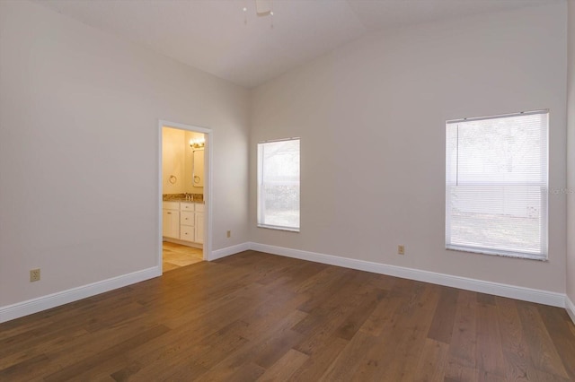 unfurnished room featuring ceiling fan, lofted ceiling, hardwood / wood-style floors, and plenty of natural light