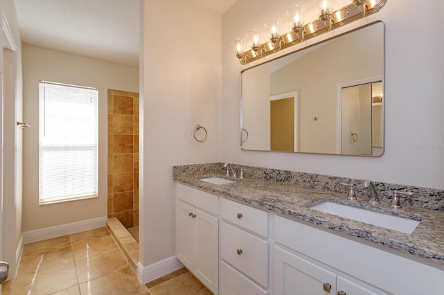 bathroom with vanity, tile patterned floors, and tiled shower