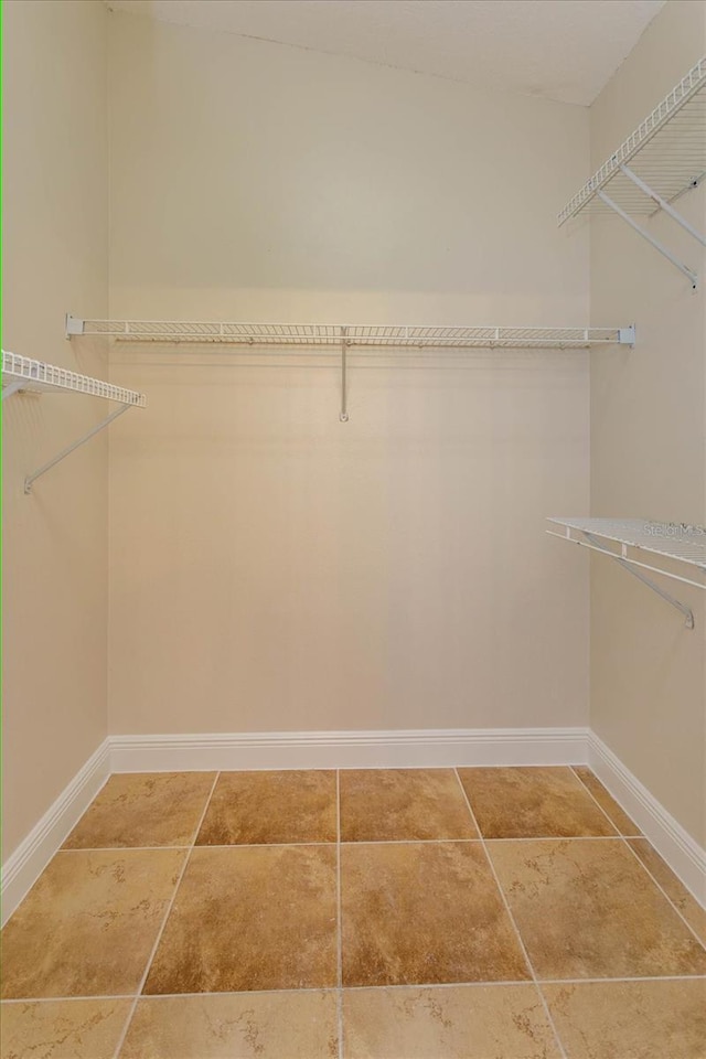 spacious closet with tile patterned floors