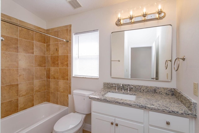 full bathroom with vanity, toilet, and tiled shower / bath combo