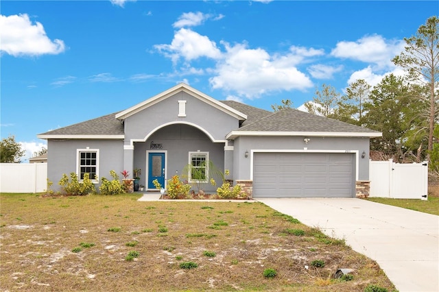 ranch-style house with a garage and a front yard