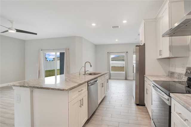 kitchen featuring white cabinetry, sink, stainless steel appliances, a center island with sink, and wall chimney exhaust hood