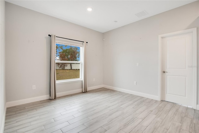 unfurnished room with light hardwood / wood-style flooring