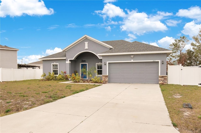 view of front facade with a garage and a front lawn