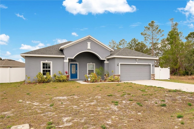 ranch-style home with a garage and a front yard