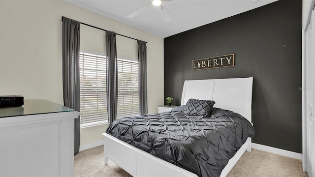 bedroom featuring light colored carpet and ceiling fan