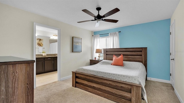 carpeted bedroom with ceiling fan and ensuite bathroom