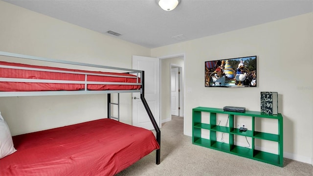 bedroom featuring carpet floors and a textured ceiling