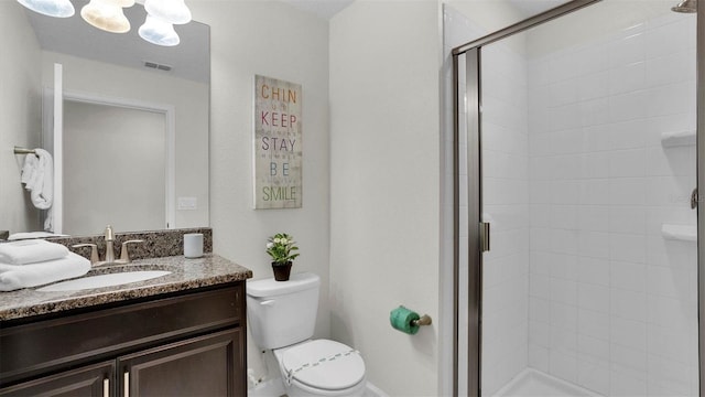 bathroom with vanity, toilet, a chandelier, and a shower with door