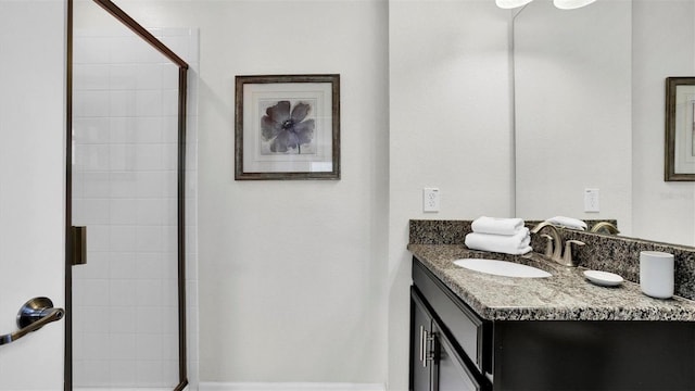 bathroom with vanity and tiled shower