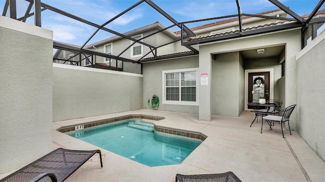 view of swimming pool with a lanai and a patio area