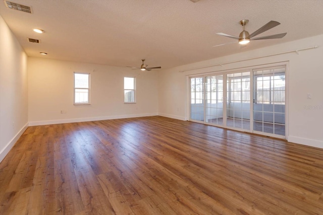 spare room featuring ceiling fan, hardwood / wood-style floors, and a textured ceiling