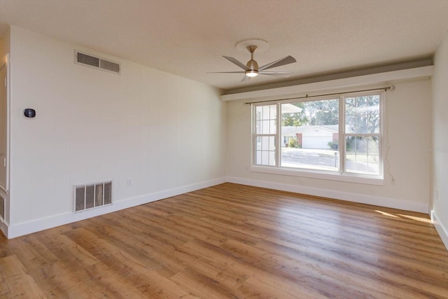 spare room featuring ceiling fan, a textured ceiling, and light wood-type flooring