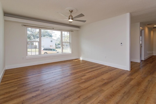 unfurnished room with hardwood / wood-style flooring, a textured ceiling, and ceiling fan